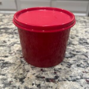 Tupperware red sparkle canister with solid red lid 4” wide by 3” tall.